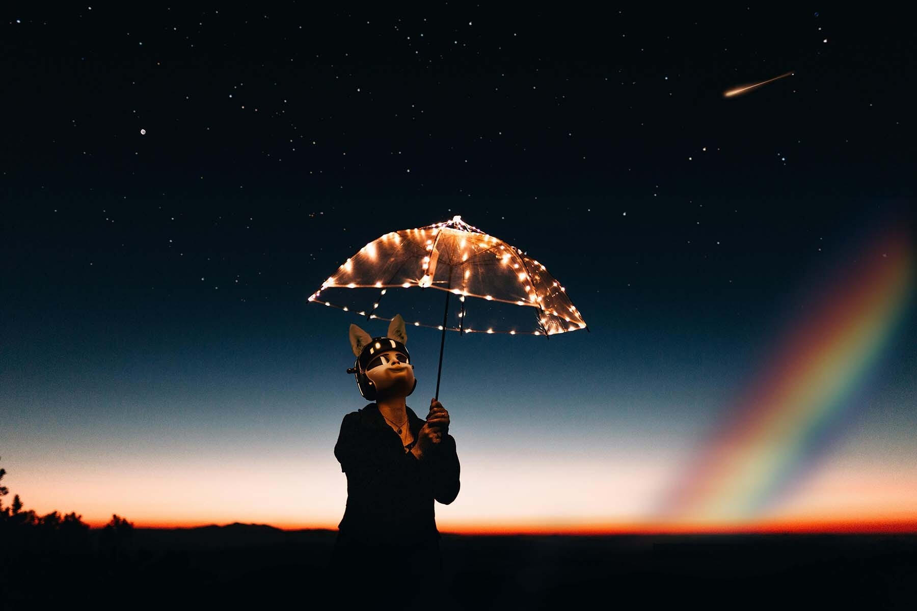 A space cat under an umbrella of LED lights with a rainbow